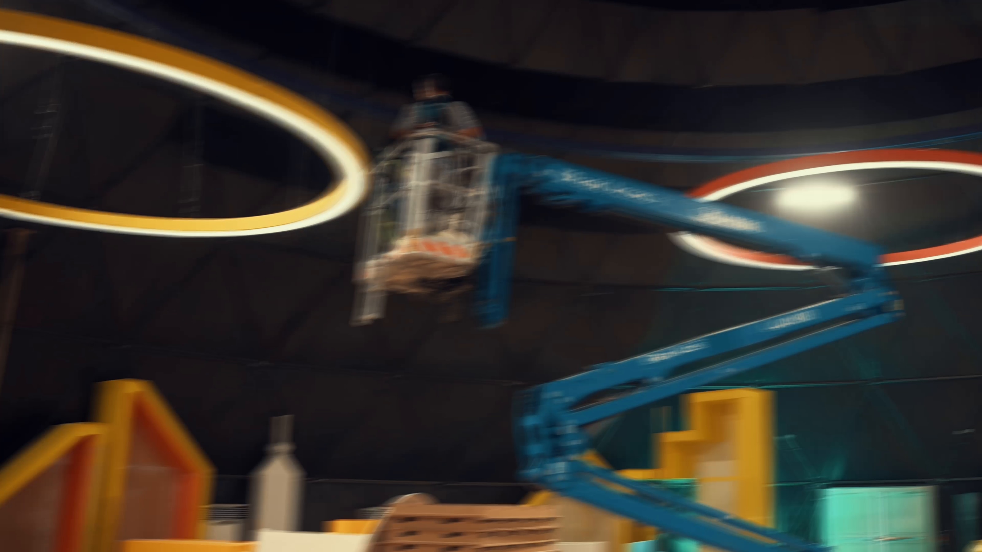 Crew on a lift rigging light rings inside the dome
