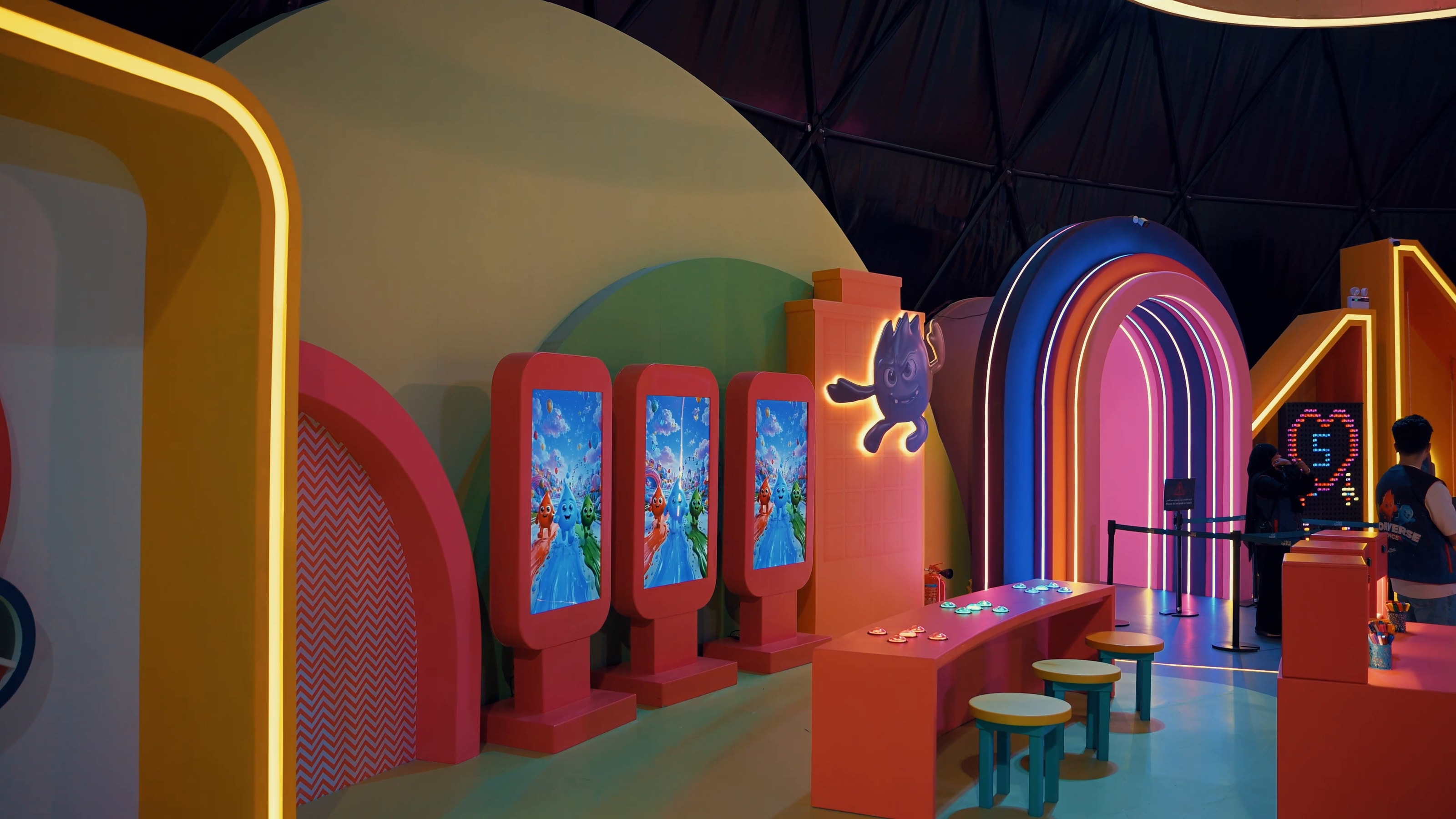 Games room with colourful arches and screens