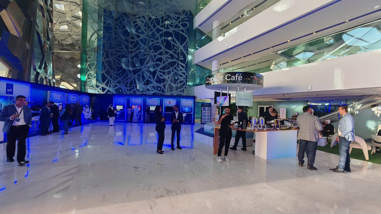 Expo hall with blue-lit demo stations