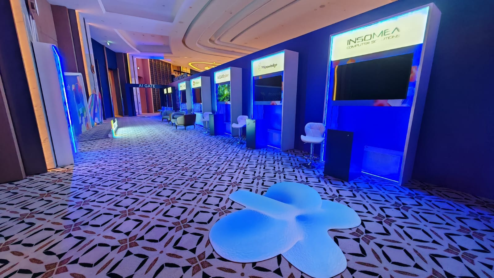 Expo corridor lined with lit demo stations