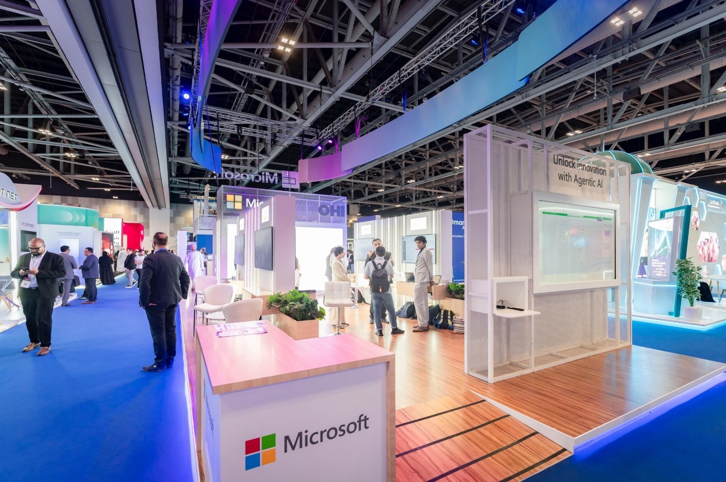 Booth counters with a lit Microsoft logo along the aisle