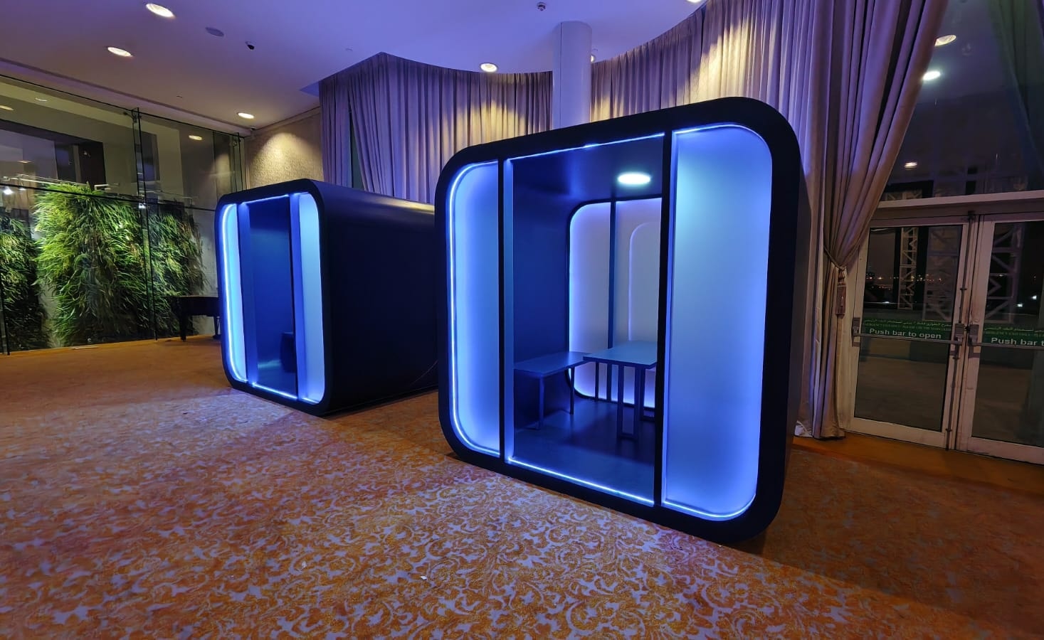 Enclosed meeting pods outlined in blue light
