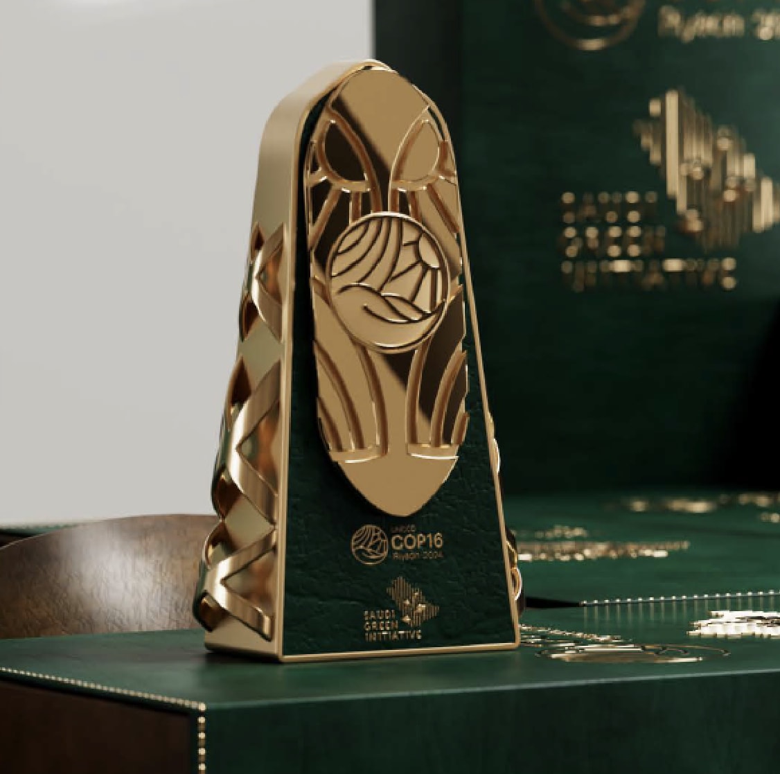 Gold faceted trophy on a green backdrop