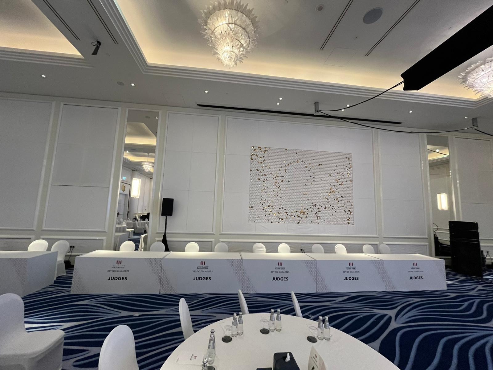 Head table in front of a white feature wall
