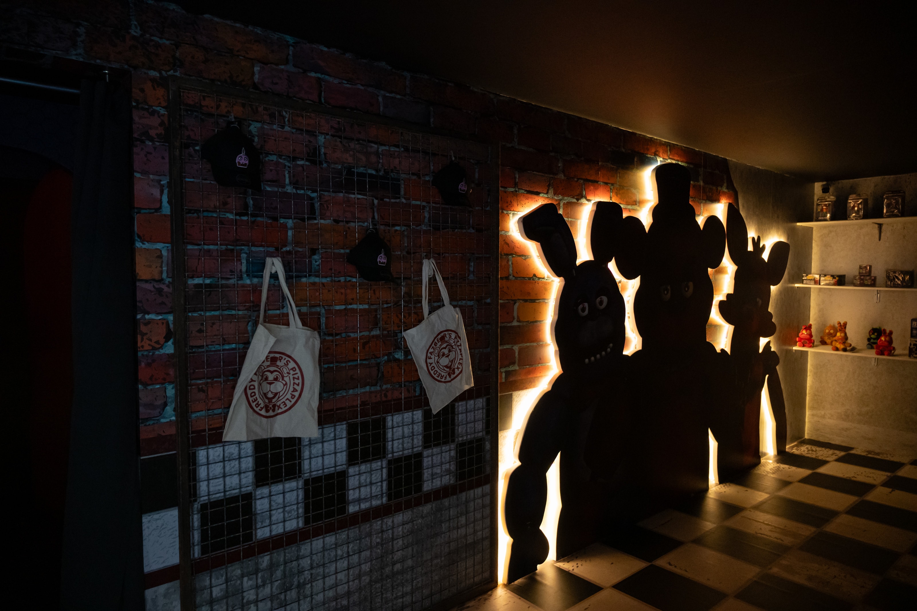 Backlit figure silhouettes inside the Horror Attraction