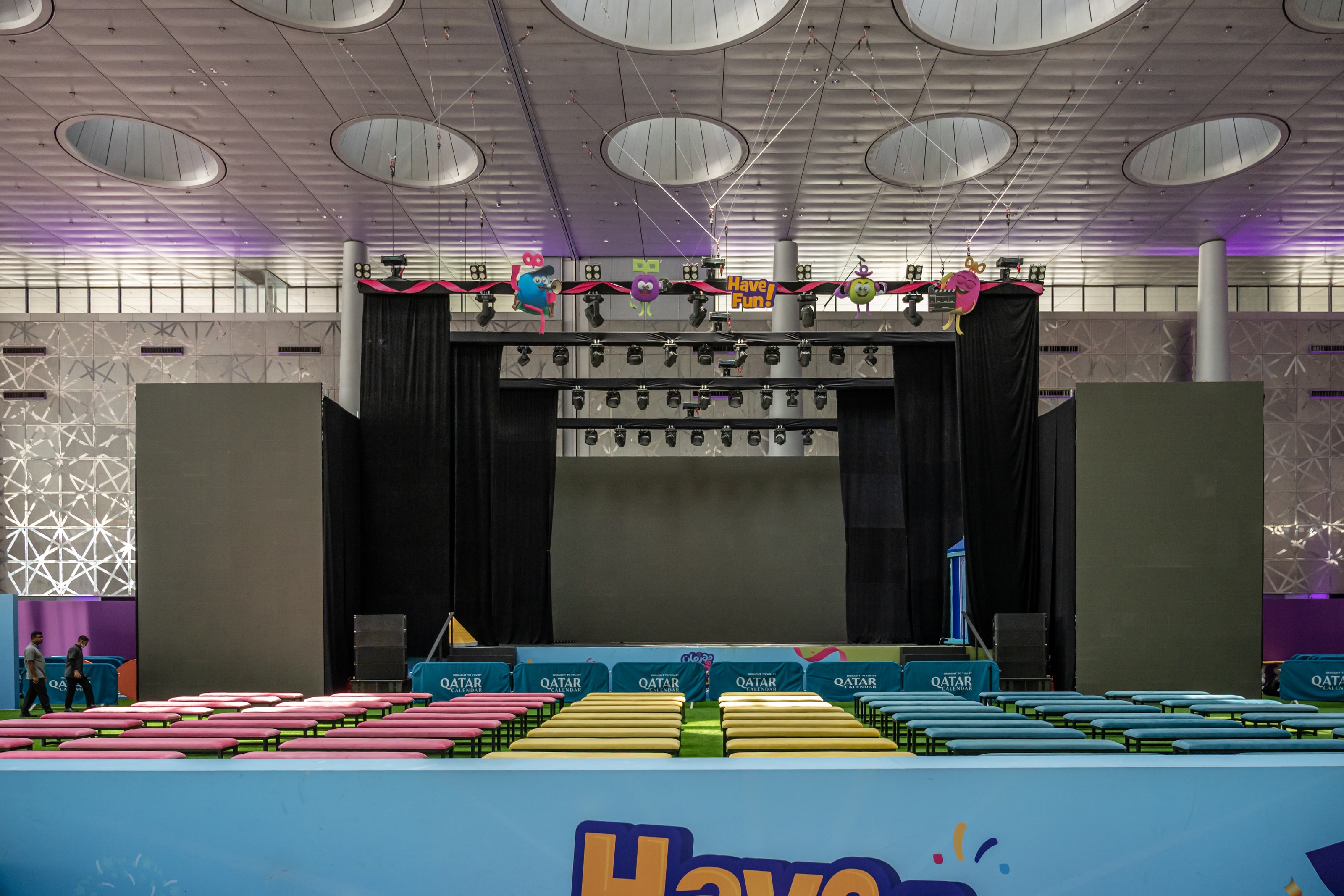 Main stage with rows of colourful bench seating