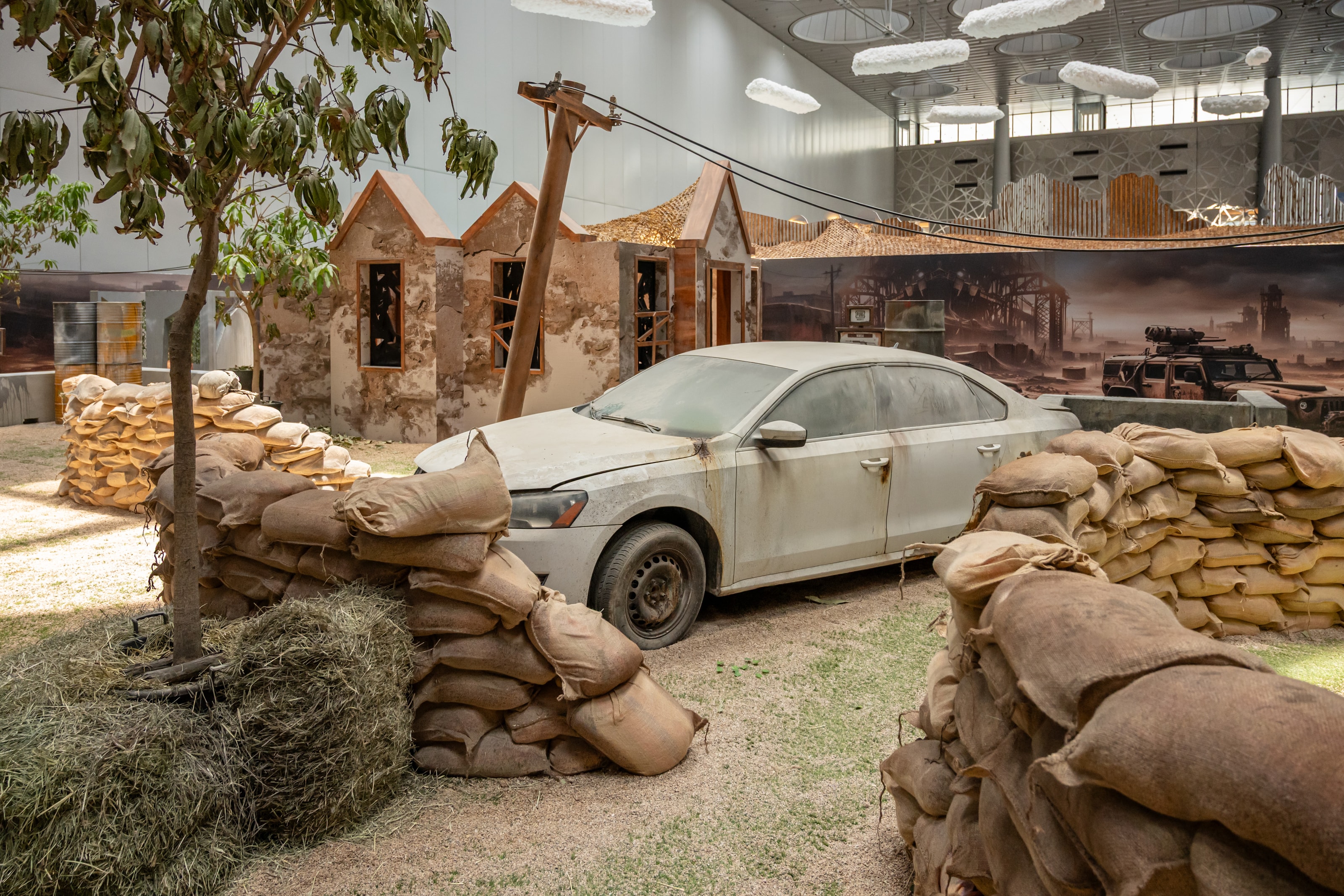 Sandbag bunker beside an abandoned car