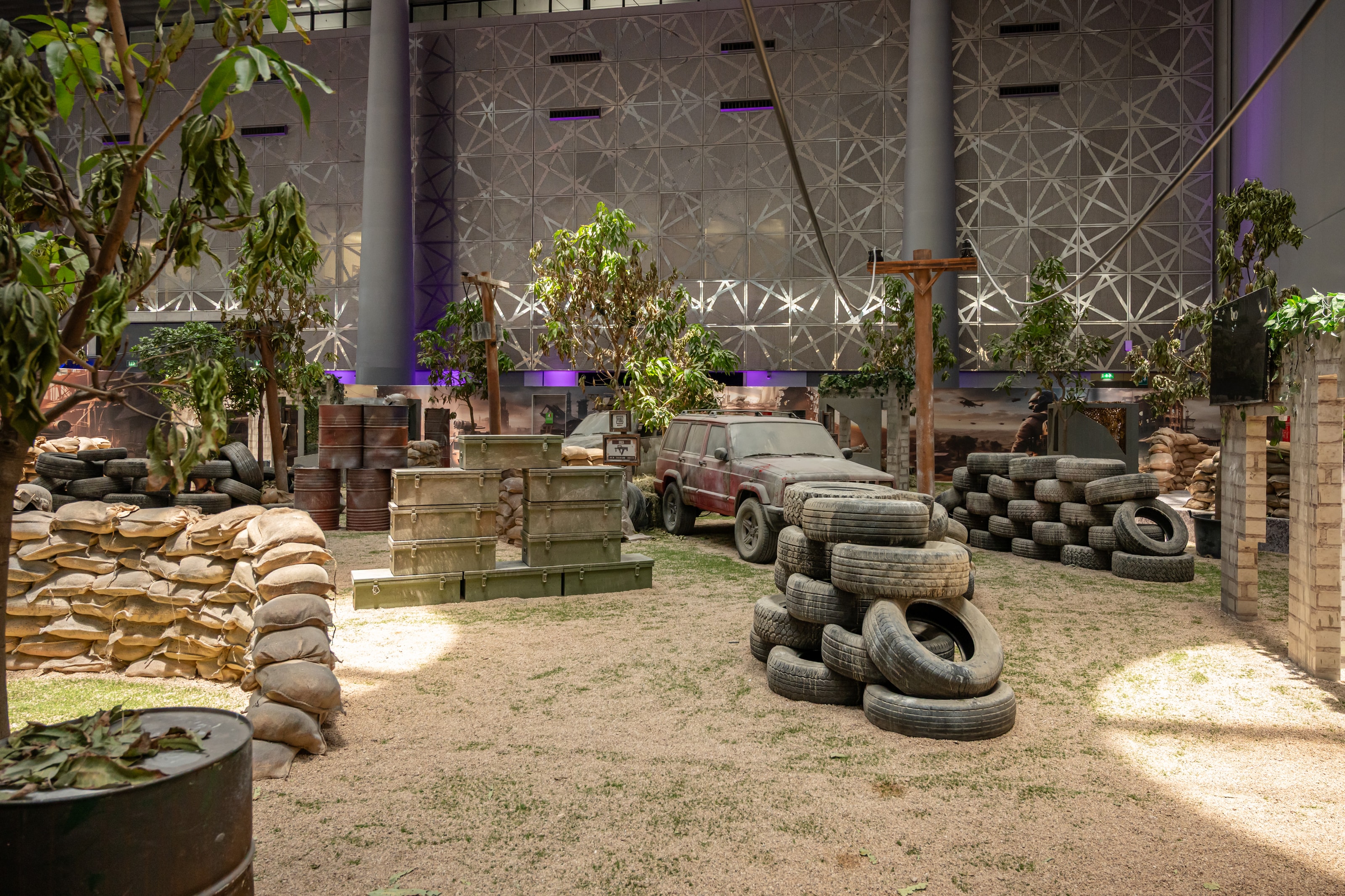 Battleground with stacked tyres and trees