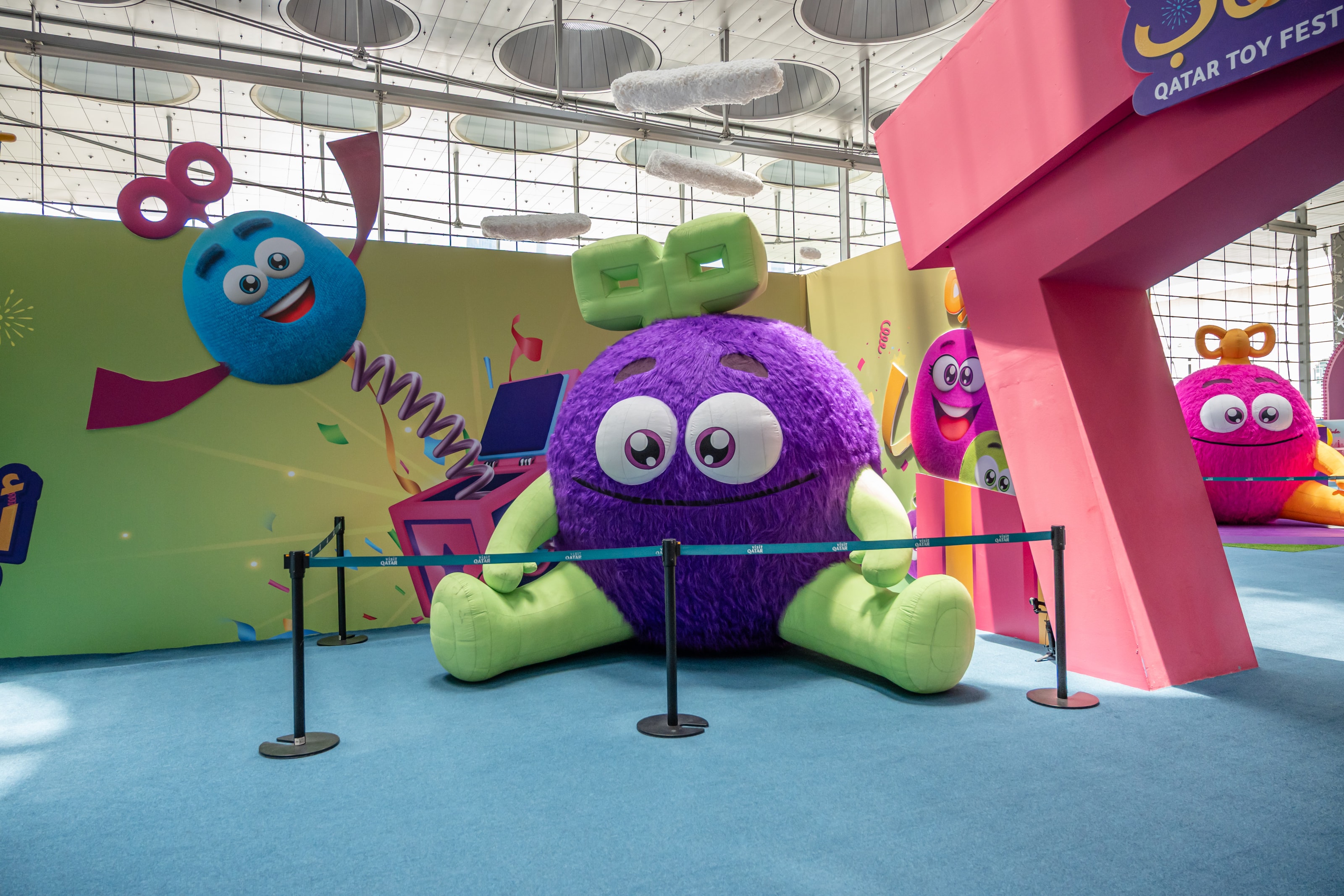 Giant purple plush monster on the festival floor
