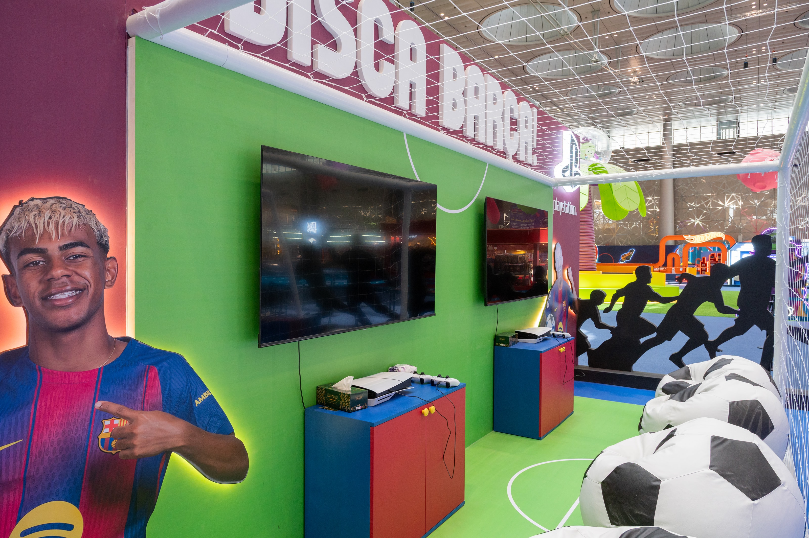 Player portrait wall beside football bean bags
