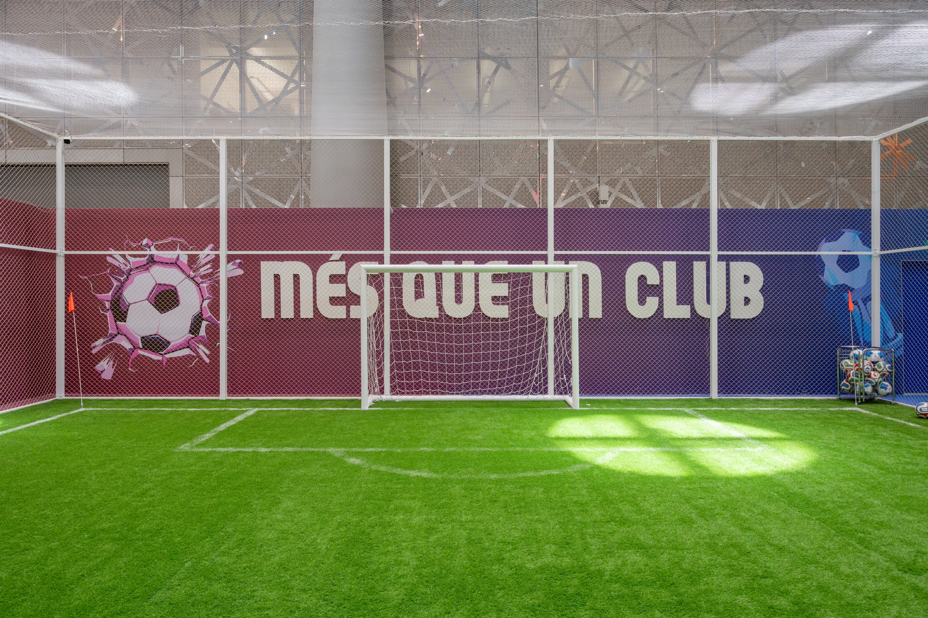 Indoor pitch with “Més que un club” wall graphic