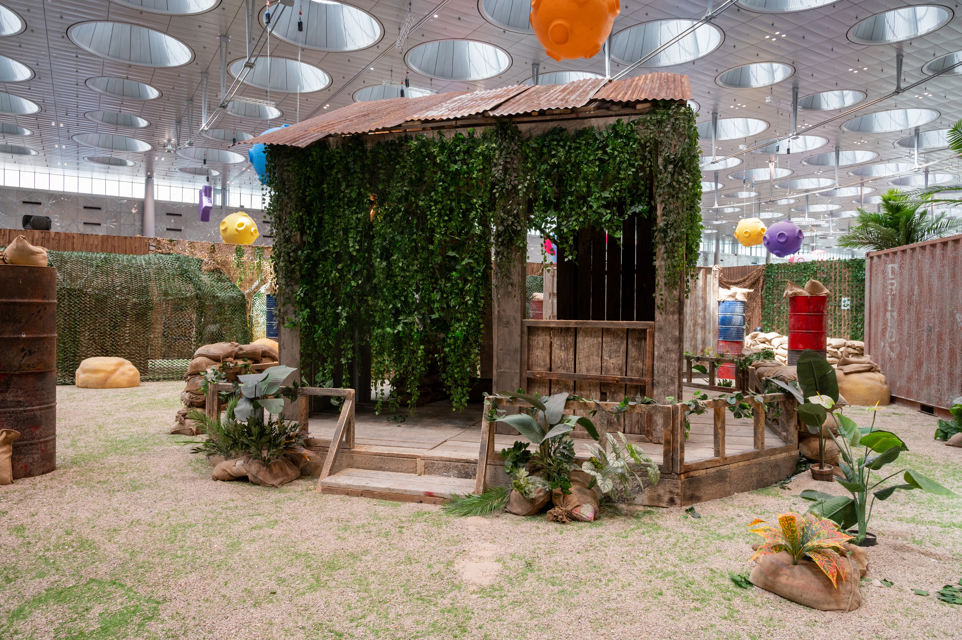 Timber jungle hut with sandbags and foliage