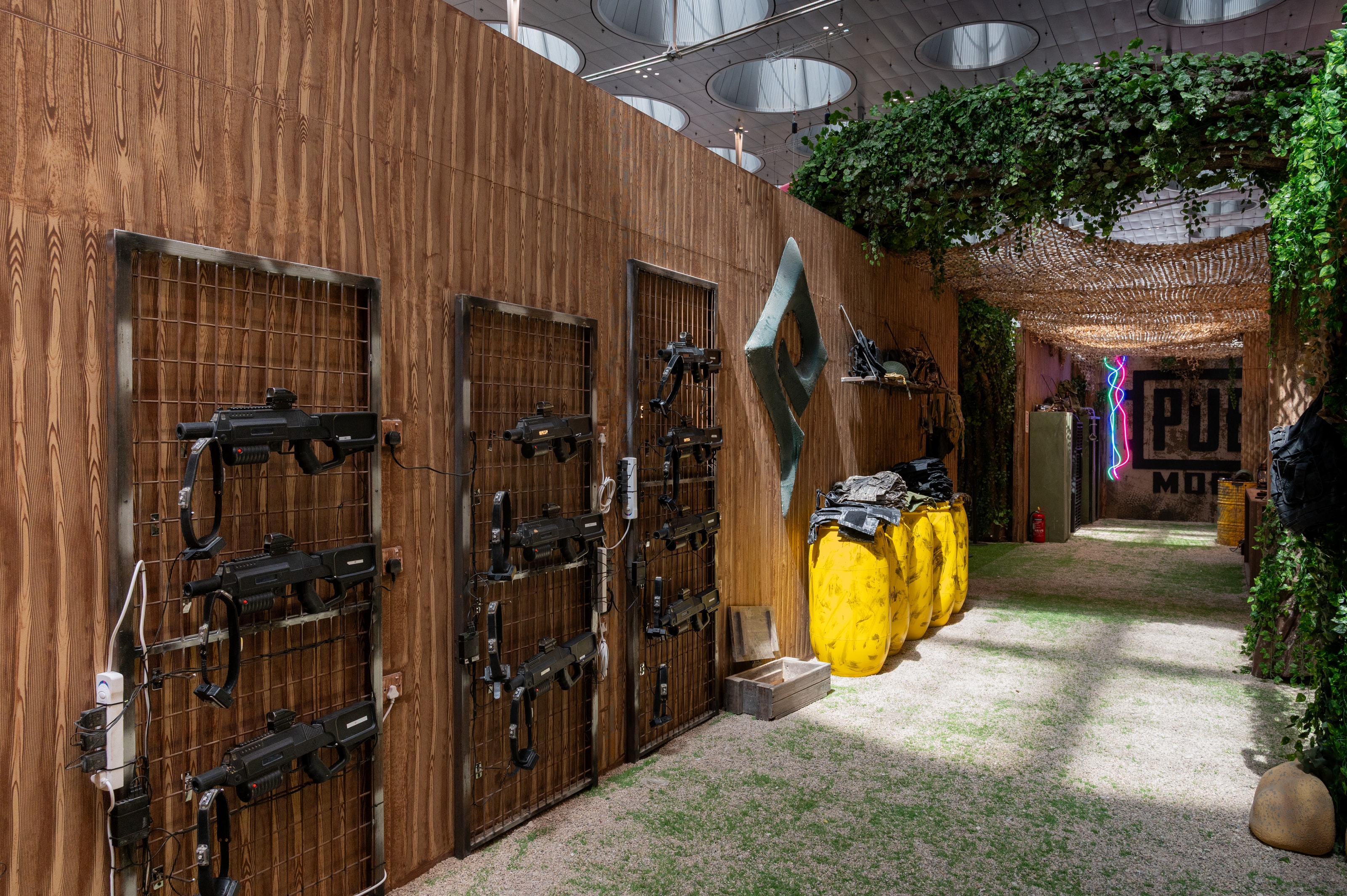 Replica weapons wall in a timber corridor