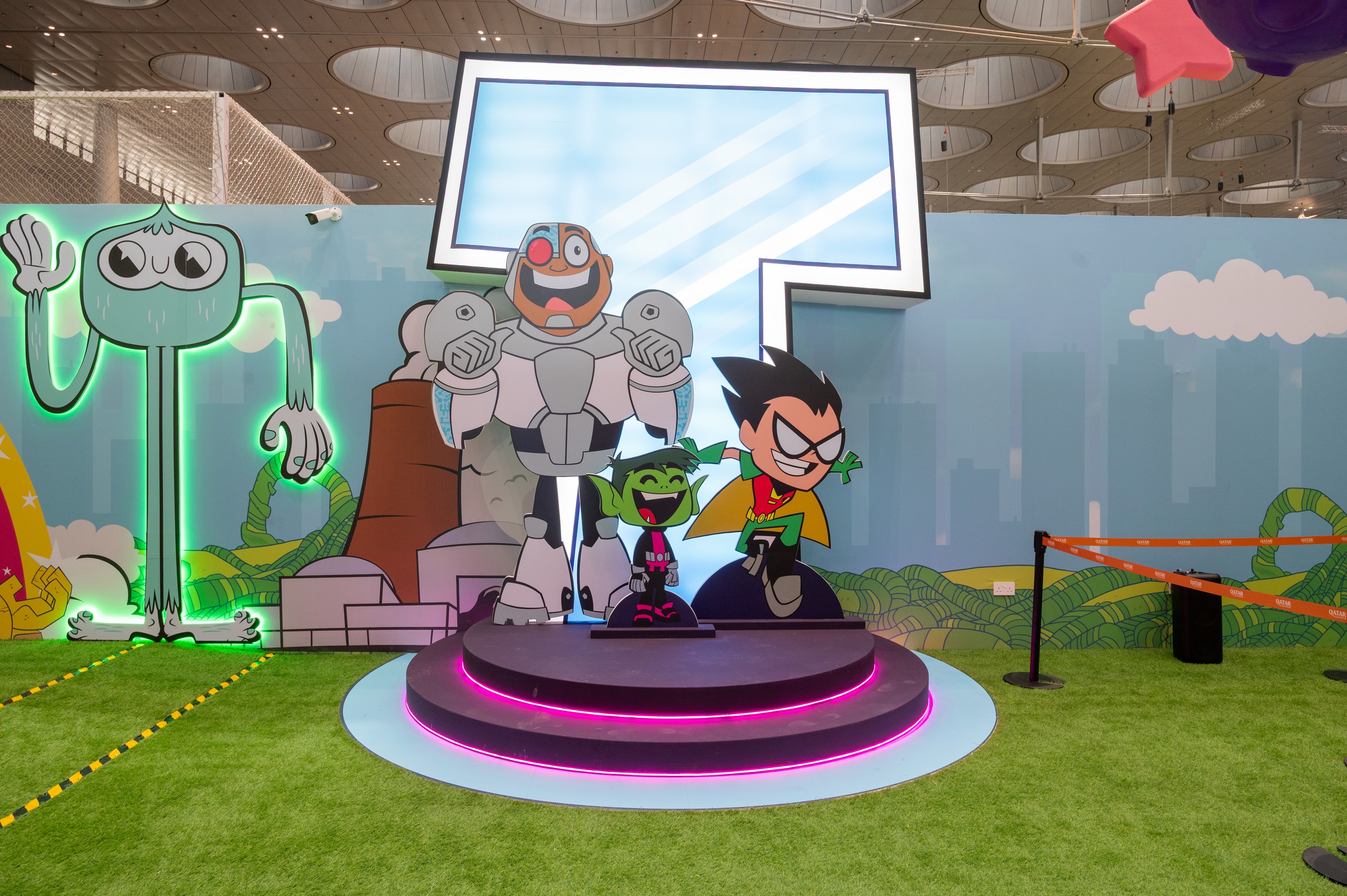 Teen Titans Go! character statues on a lit plinth