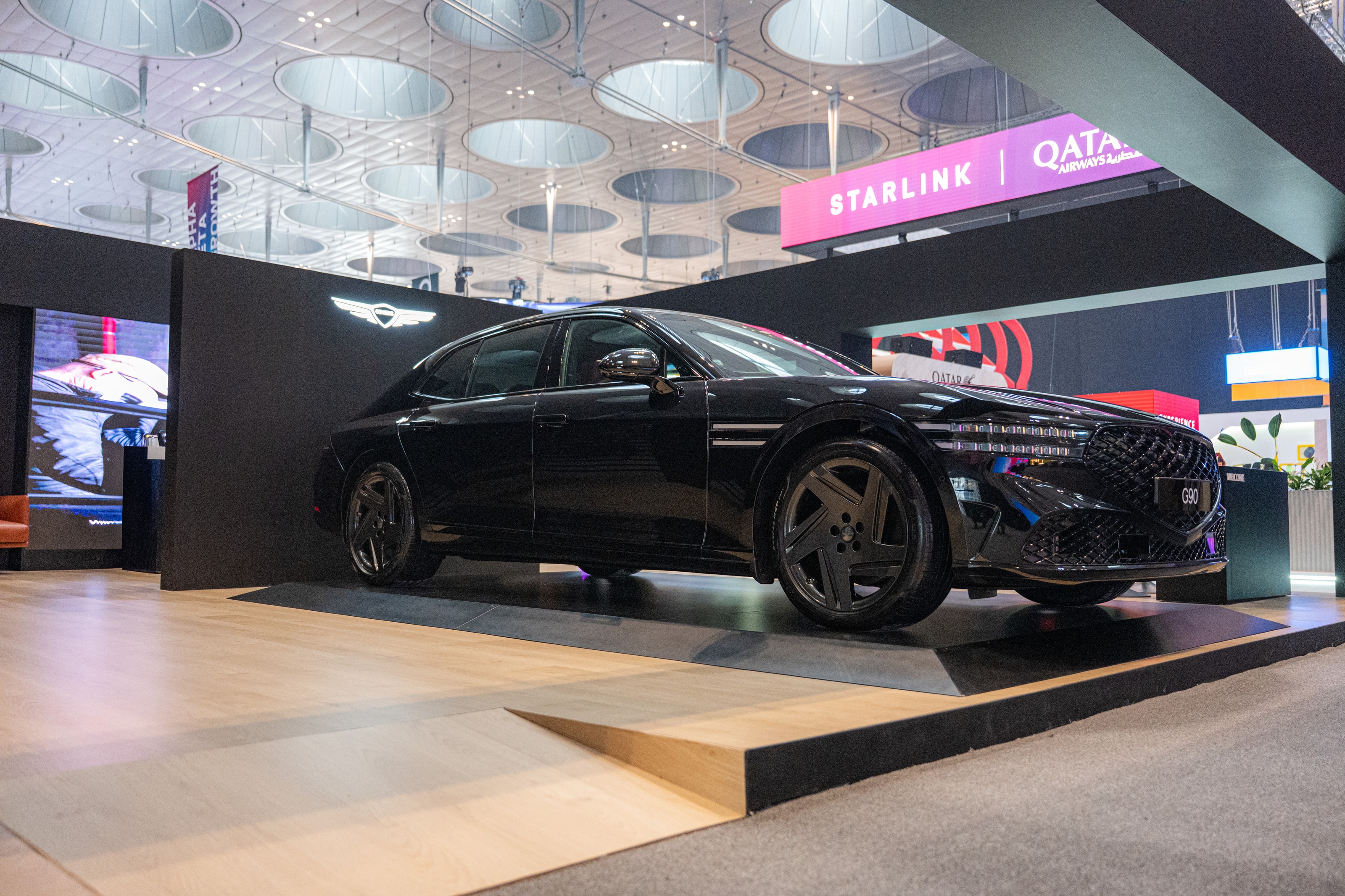 Side view of the Genesis G90 on the pavilion floor