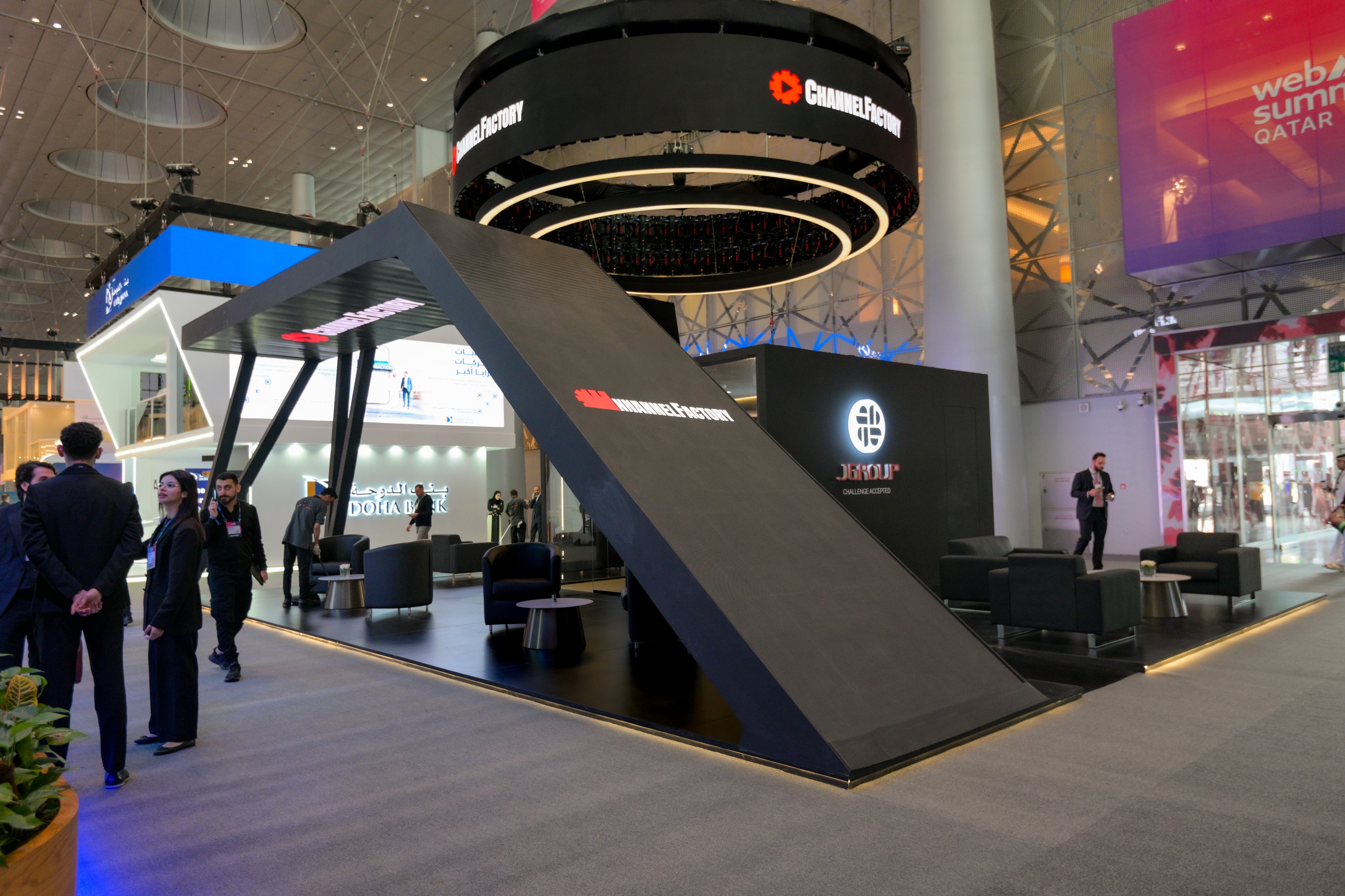 J Group stand at Web Summit 2026 with a circular halo sign