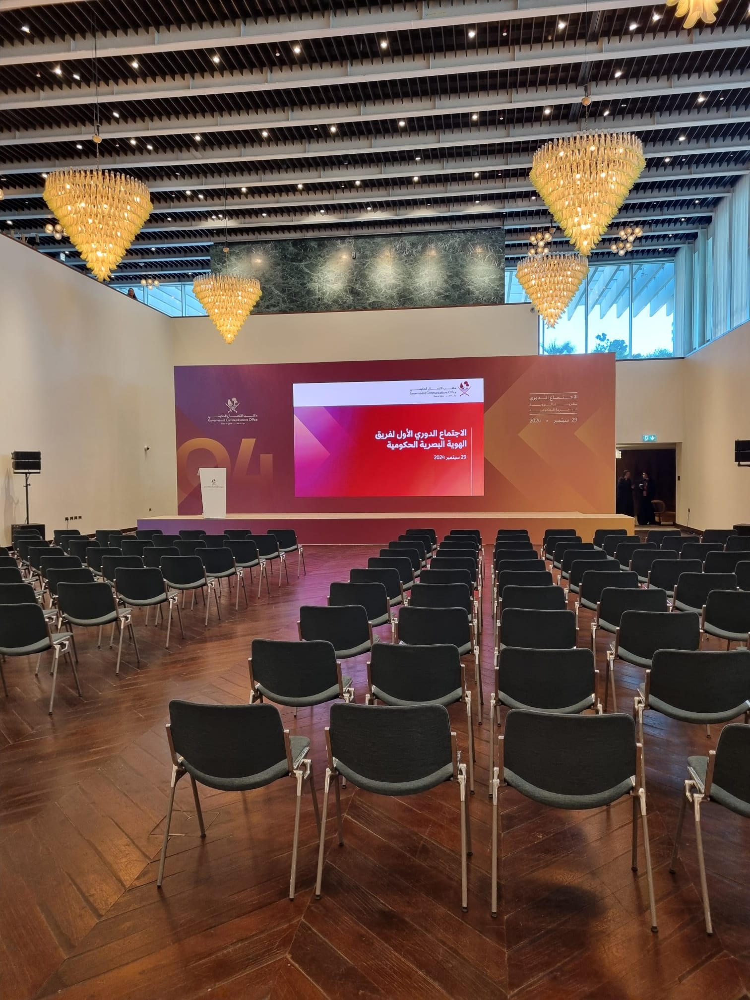 Workshop hall with chandeliers and rows of seating